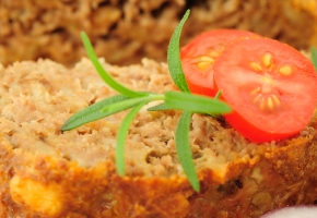 Close-up of meat loaf on wooden cutting board selective focus